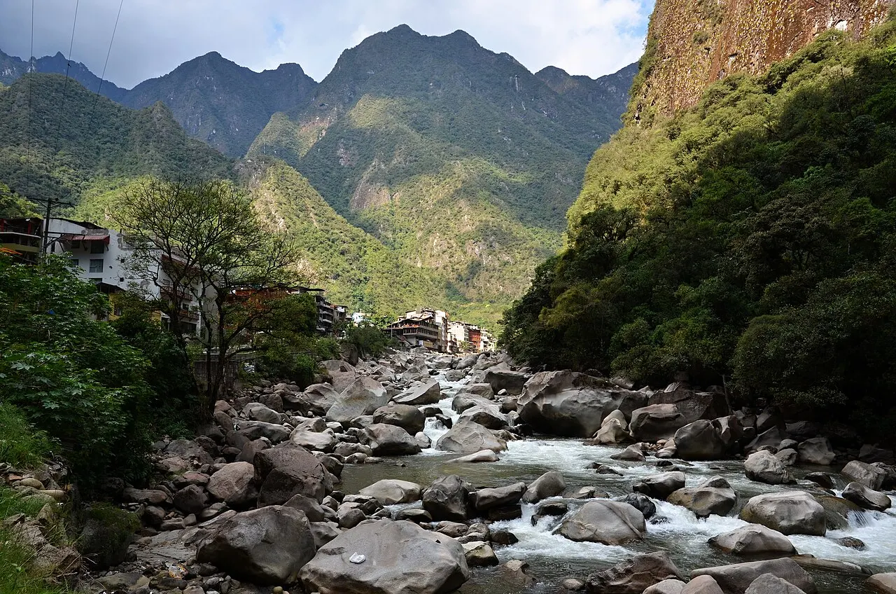 Riverside buildings of Aguas Calientes lining the rushing Urubamba river