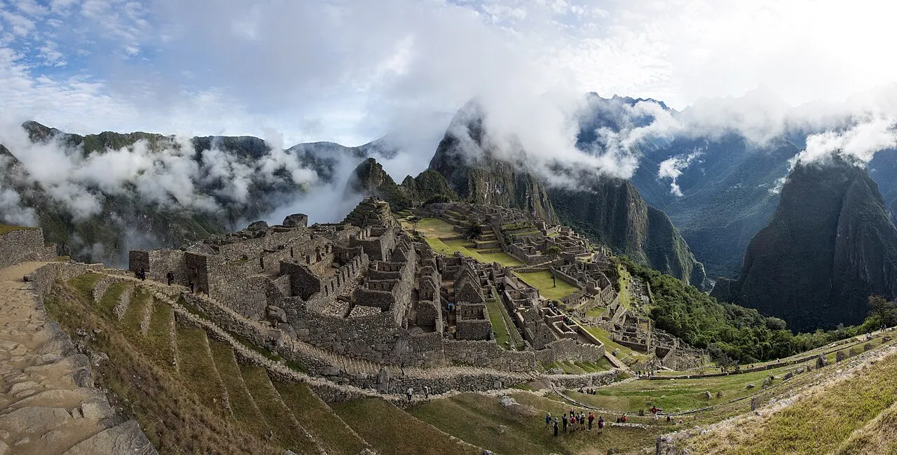 The Machu Picchu citadel with morning cloud lifting dramatically off the surrounding peaks