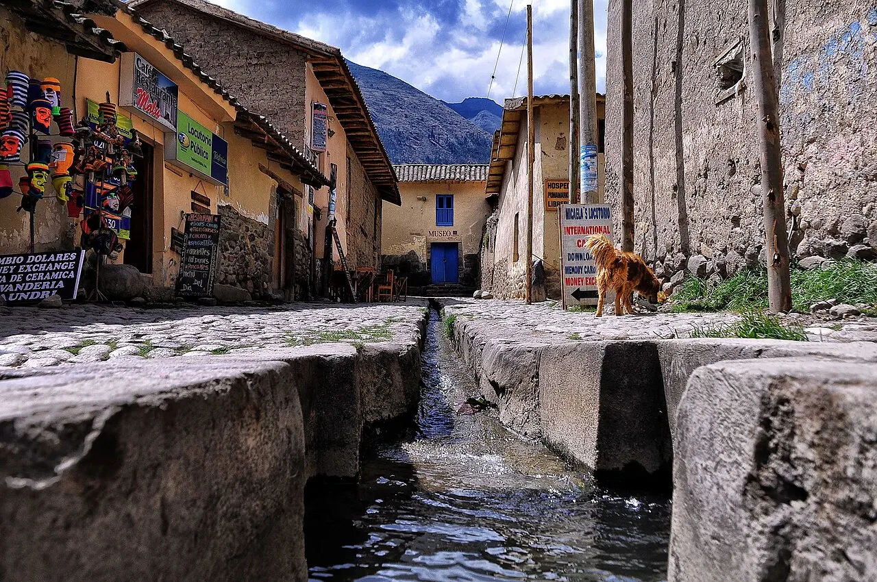 Water running in the original Inca channel along a cobbled street in Ollantaytambo