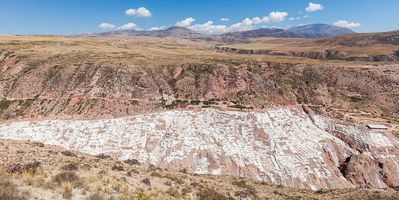 The white terraced salt evaporation ponds of Maras cascading down the hillside in the Sacred Valley