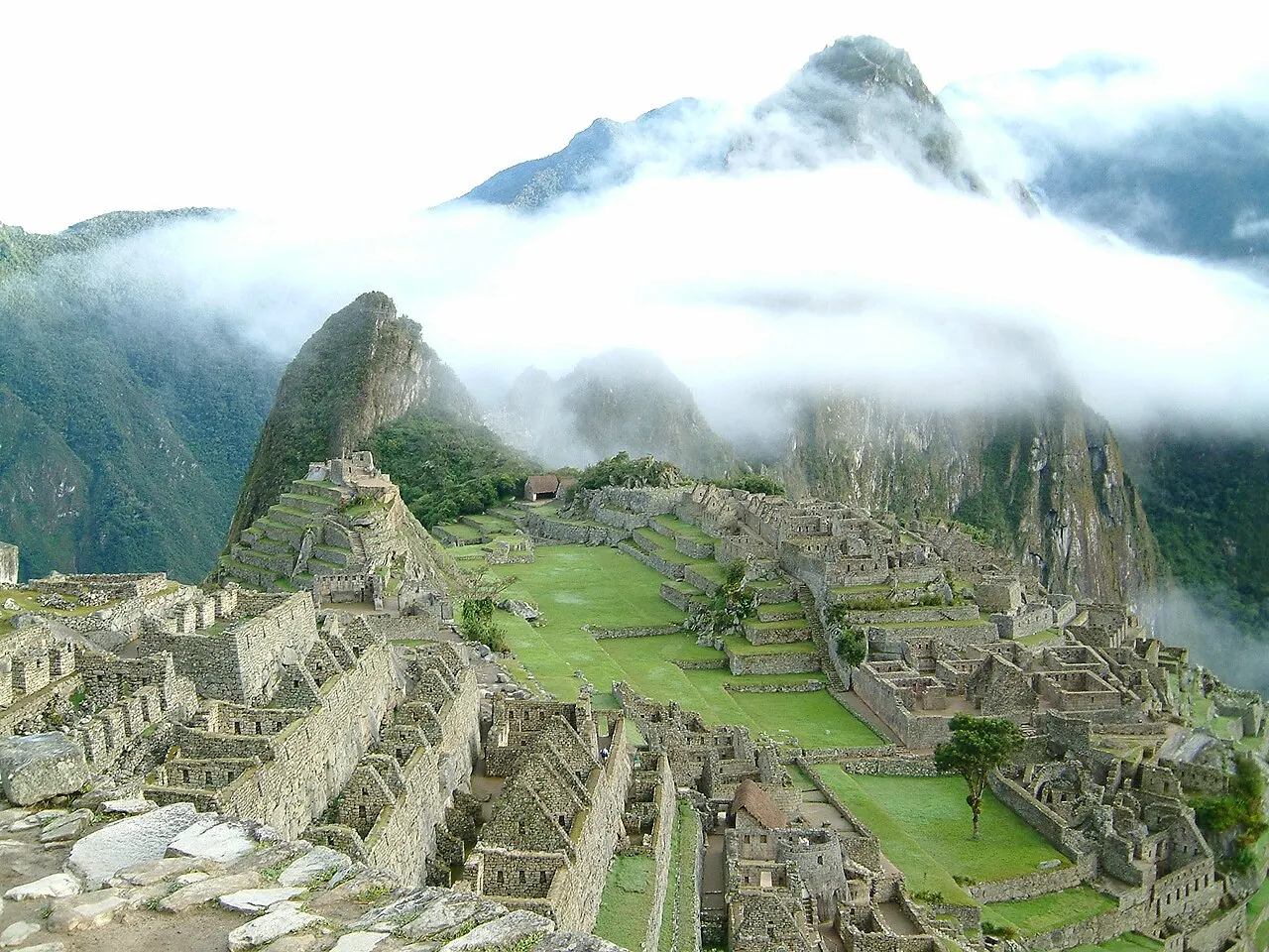 Machu Picchu in the early morning with a band of cloud lifting off the terraces and peaks